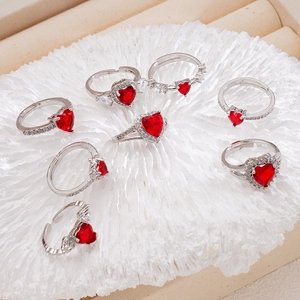Adjustable silver heart ring with red cubic zirconia on elegant white coral base