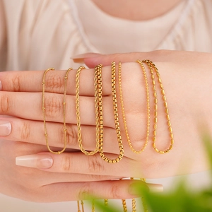 Set of five gold stainless steel necklaces with different minimalist chain textures