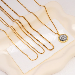 St. Benedict medal necklace in two-tone gold and silver on assorted stainless steel chains