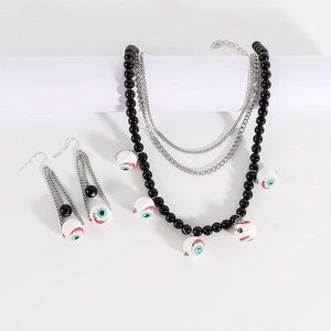 Macro view of multi-layer beaded necklace and earrings with realistic eyeball charms