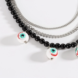 Close-up of gothic layered necklace with realistic bloodshot eyeball pendants