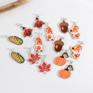 Thanksgiving themed wooden earrings with turkey, pumpkin and gnome designs on white background