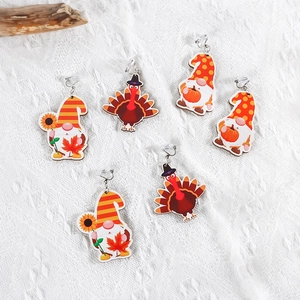 Detailed view of Thanksgiving wooden earrings featuring turkey and gnome prints