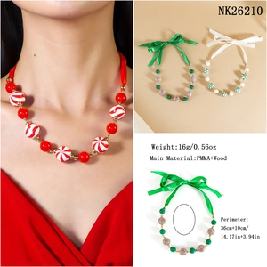 Macro view of Christmas beaded necklace made of PMMA and wood with ribbon bow detail
