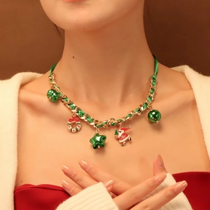 Christmas necklace with Santa charms and green ribbon woven in a gold chain on model