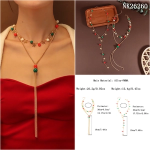 Detail view of gold beaded Christmas necklace set with red green white beads and star charms
