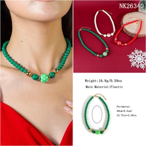 Detail of Christmas beaded necklace featuring festive red white and green snowflake beads