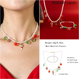 Detailed view of Christmas jewelry set with white pearls and festive enamel charms