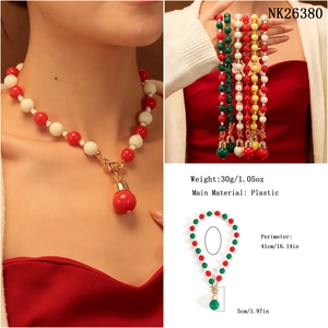 Detailed view of colorful Christmas beaded necklace with gold toggle clasp and bell charm