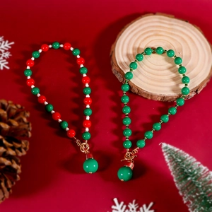 Gros plan du collier de Noël en perles rouges et vertes avec fermoir en métal doré OT