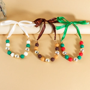 Three-piece acrylic bead necklace set with satin ribbons in festive vintage colorways