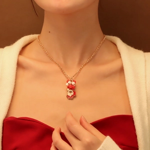 Chic Christmas necklace with Santa Claus pendant and festive red-white beads on gold chain