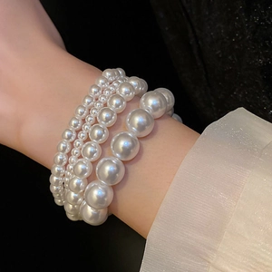 Elegant multi-layered elastic pearl bracelets in various sizes for women set on wrist
