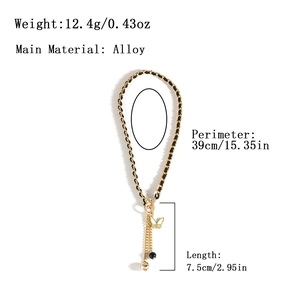 Vintage velvet bow necklace with gold chain and heart tassel on a white background