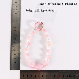 Pink beaded phone lanyard with cute heart and rose charms and spring ring clasp