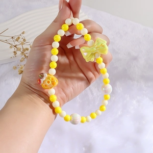 Sweet yellow strawberry cake style beaded phone lanyard with resin bow and honeycomb charms