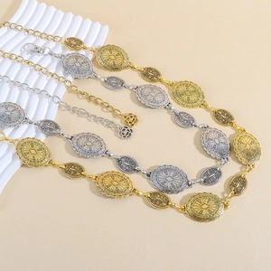 Detailed close-up of retro metal waist chains with embossed patterns in gold and silver
