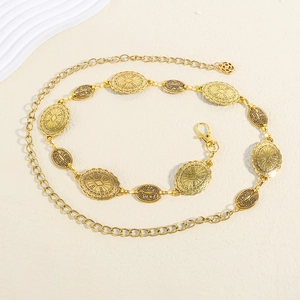 Detail of vintage gold chain belt with embossed floral medals and lobster clasp