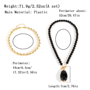 Two-layer beaded necklace set with gold and black beads and large oval teardrop pendant
