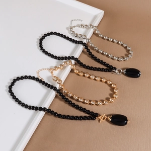 Two-piece multi-layered beaded necklace with vintage teardrop pendant and OT clasp