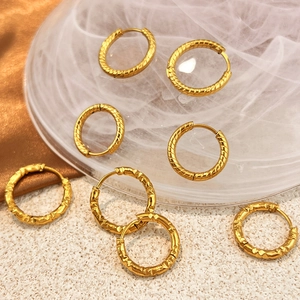 Golden 18K titanium steel hoop earrings with twisted and hammered texture designs