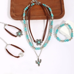 Detail of western turquoise jewelry set with engraved cactus and flower charms