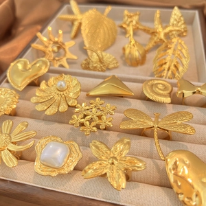 Golden titanium steel rings set featuring heart, dragonfly, and starfish floral designs