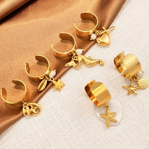 Golden sea star shell pendant rings set in stainless steel with marine charms