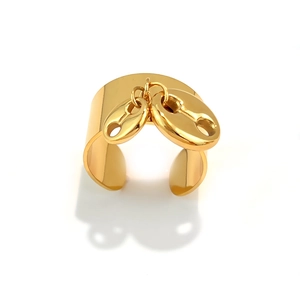 Polished gold stainless steel wide open ring with hanging coffee bean pendants on white background