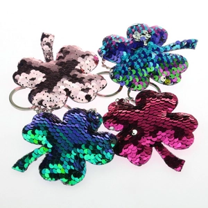 Detail of four-leaf clover keychains with colorful reversible flip sequins and silver rings