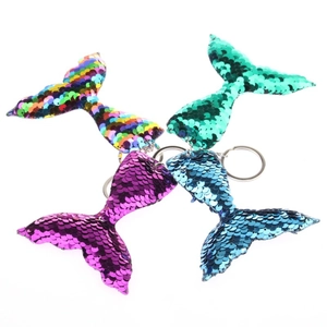Detailed view of four flip sequin mermaid tail keychains in vibrant rainbow colors