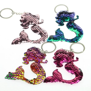 Detail of four assorted sequin mermaid keychains with reversible scales and silver rings