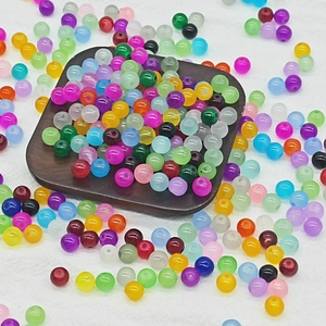 Macro shot of 8mm multicolored smooth glass beads with pre-drilled holes for DIY jewelry