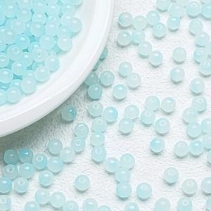 Macro shot of 6mm-8mm light blue gradient translucent glass beads for DIY jewelry