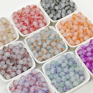 Macro detail of multicolored 8mm glass beads with unique floral texture for DIY jewelry