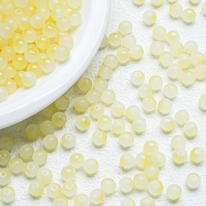 Macro shot of 6mm cream yellow gradient round beads for DIY jewelry making