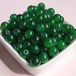 Macro shot of transparent green 8mm glass beads for DIY jewelry making crafts