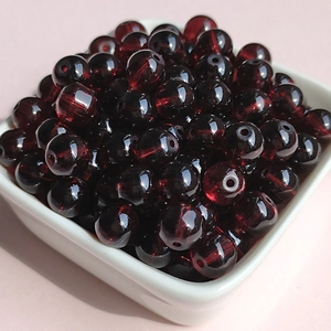 Macro shot of 8mm deep red translucent glass beads for DIY jewelry making and beading