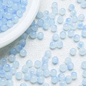 Close-up of translucent light blue 6mm gradient round glass beads for DIY jewelry making