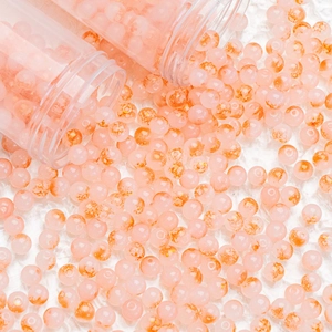 Close-up of peach pink glass beads with gold foil inclusions for DIY jewelry making