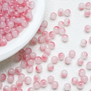 Macro shot of 8mm pink and white gradient glass beads with a smooth polished finish