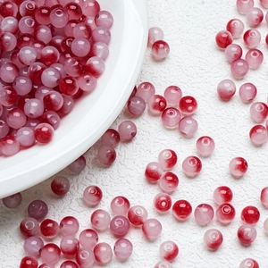 Macro shot of 8mm pink and red gradient glass beads for DIY bracelet jewelry making