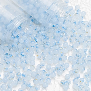 Macro shot of 8mm blue ink gold-splattered glass beads for DIY jewelry making and crafts