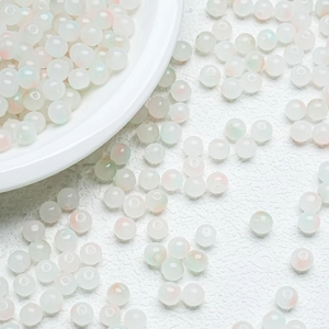 Macro detail of 8mm translucent jelly beads with subtle opalescent color shifts for DIY crafts