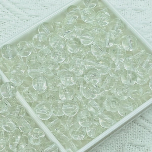 Detailed macro view of clear jelly glass beads stored in a grid organizer box