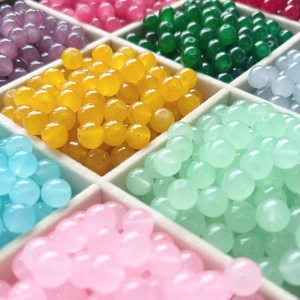 Colorful 8mm imitation jade beads organized in a grid tray for DIY jewelry making
