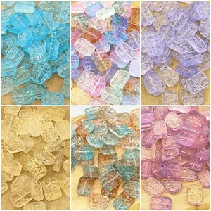 Macro detail of embossed double-sided glass flower charms in six vibrant gradient colors