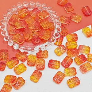 Close-up of orange double-sided glass flower beads for DIY jewelry making accessories