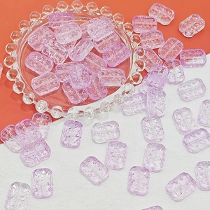 Macro shot of lavender purple rectangular glass beads with textured surface for DIY jewelry