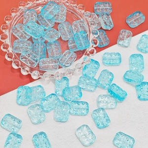 Macro shot of 13x18mm light blue glass flower beads with embossed texture for DIY jewelry